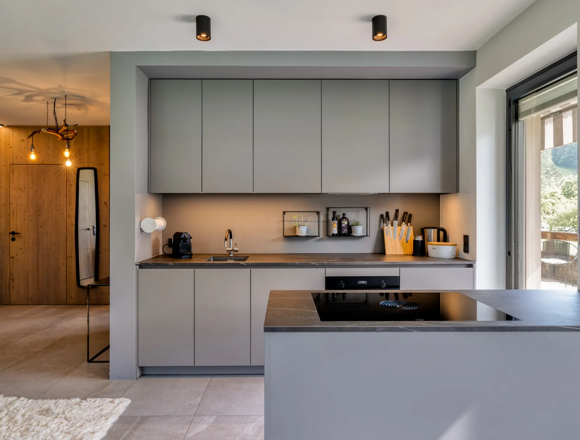 Kitchen with grey cabinets and island in Hinterstoder luxury residence