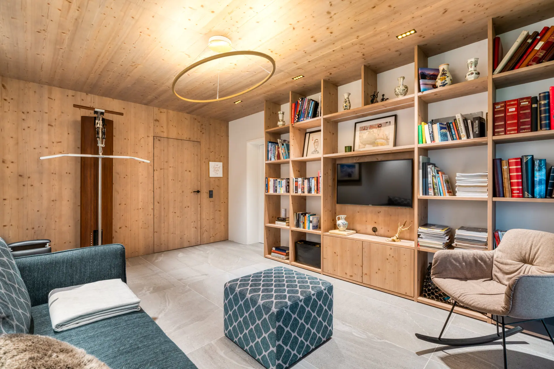 Library with wood shelving in Hinterstoder luxury ski residence