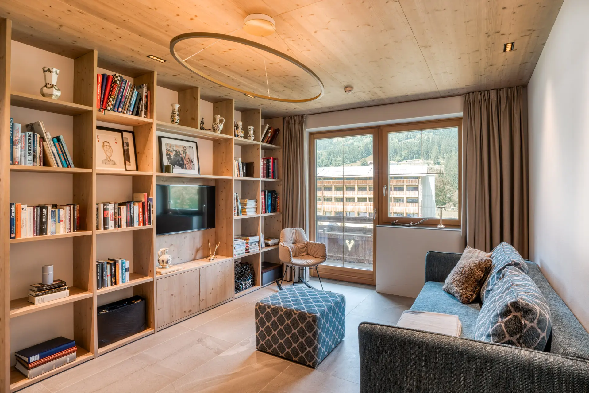 Lounge with alpine window view in Hinterstoder ski residence
