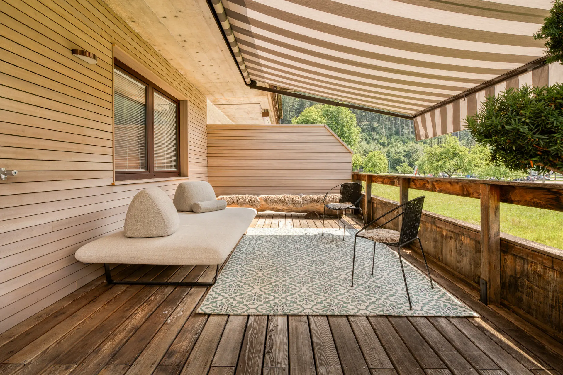 Terrace with awning and daybed at Hinterstoder luxury ski residence