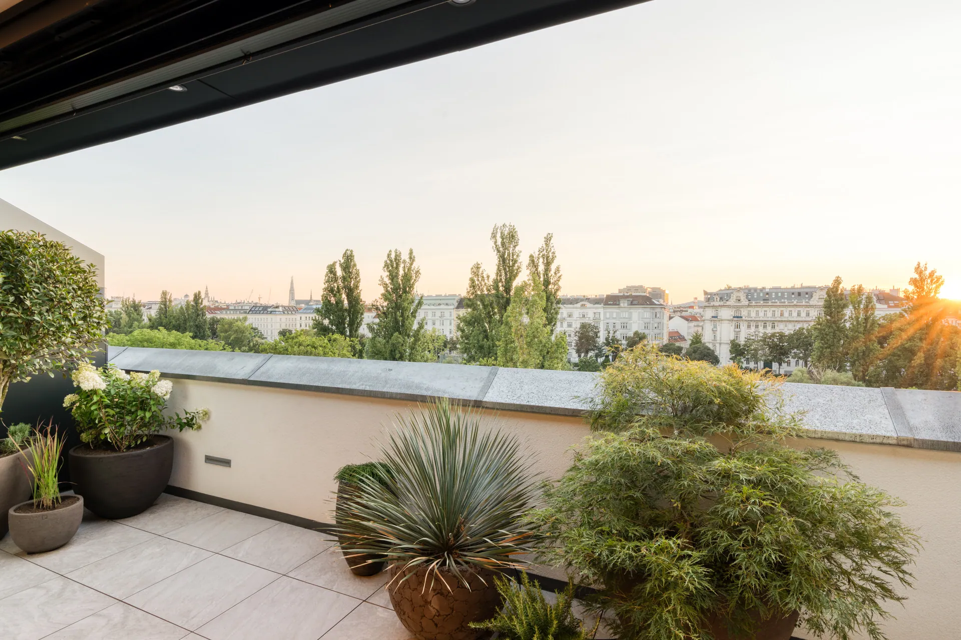 Terrace at sunset with panoramic Vienna skyline from exclusive penthouse