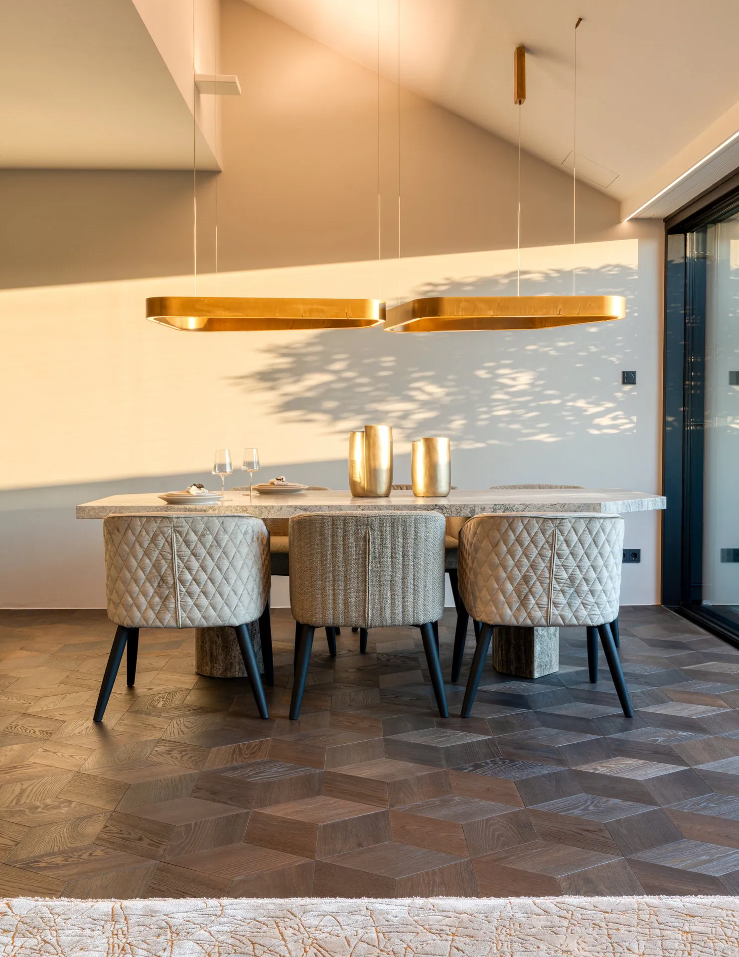 Dining table with quilted chairs in Vienna Leopoldstadt penthouse