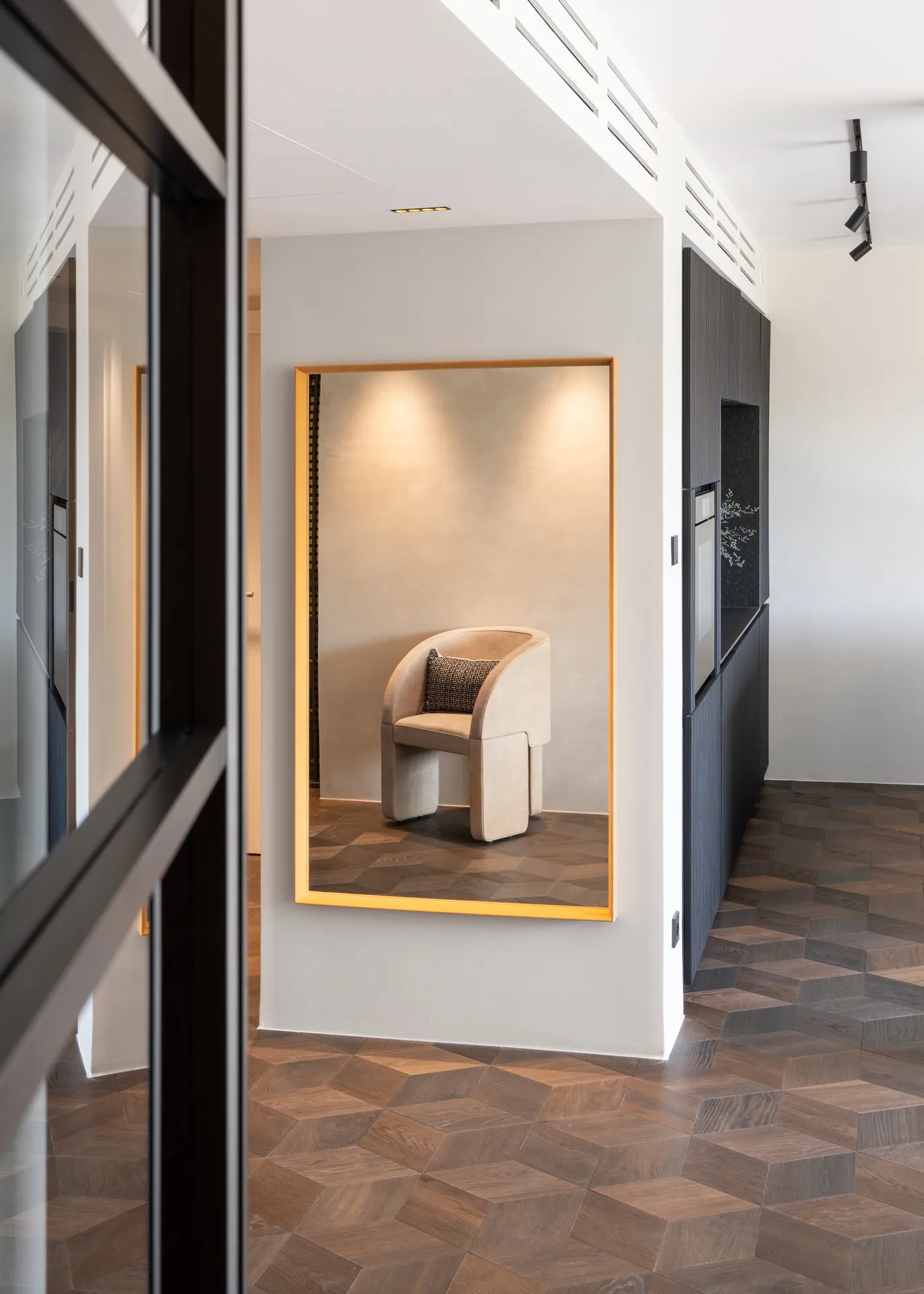 Gold-framed mirror in the hallway foyer of Vienna luxury penthouse