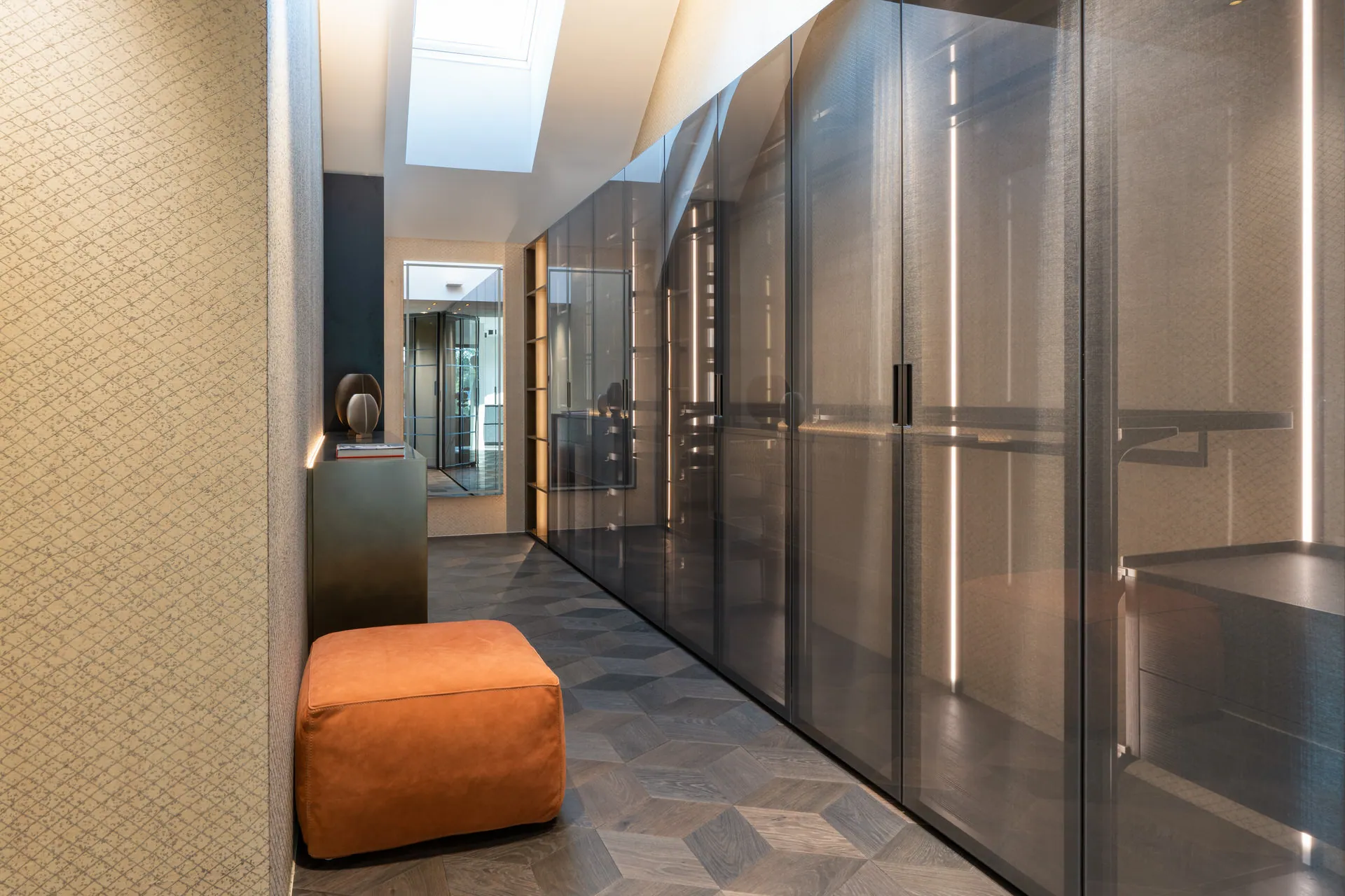 Walk-in wardrobe with smoked glass doors in Vienna penthouse apartment