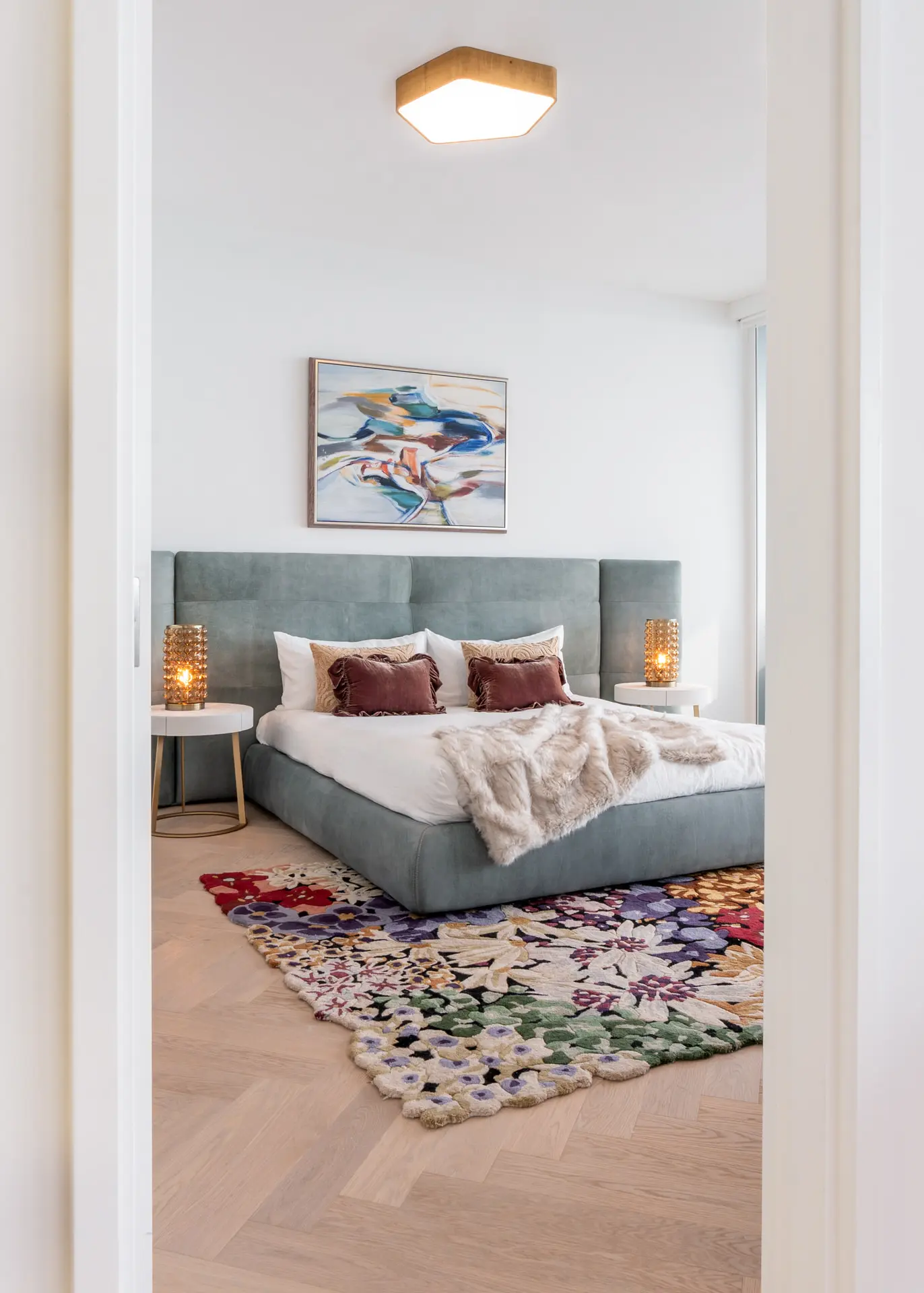 Baxter bed with floral rug at bedroom entry in Miami condo
