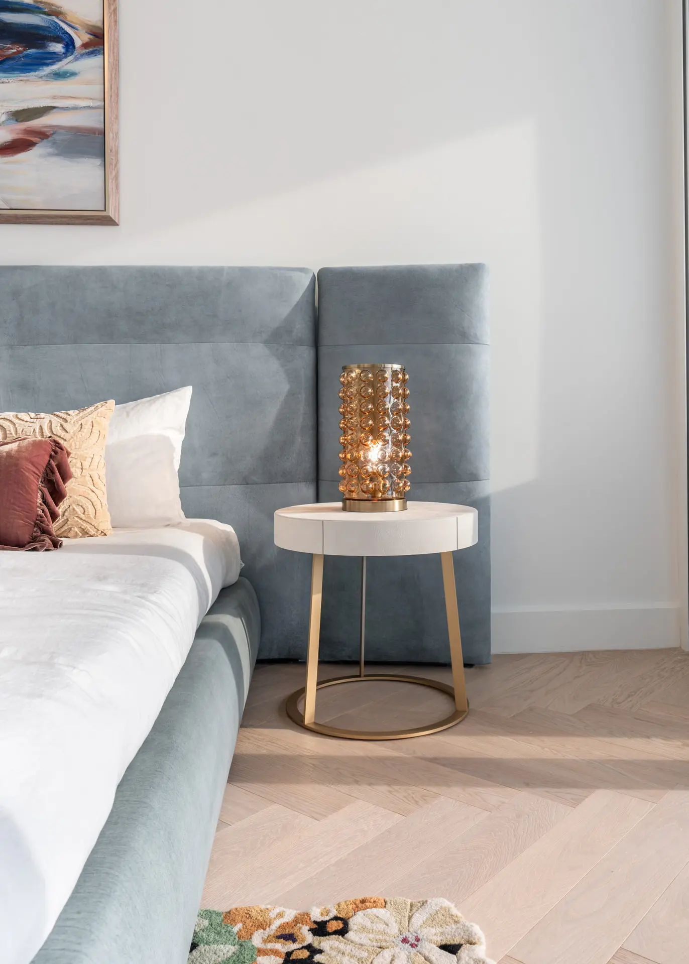 Baxter velvet headboard and crystal lamp detail in Miami penthouse bedroom