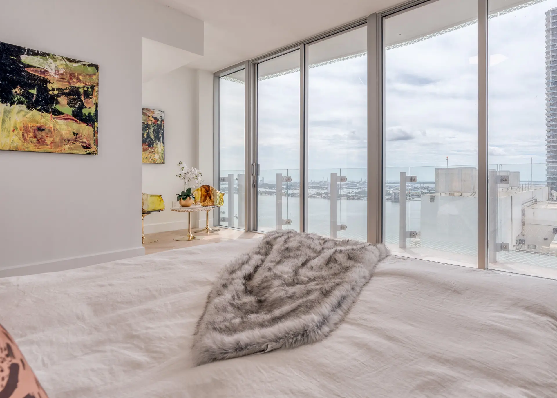Guest bedroom with waterfront glass view in Miami penthouse