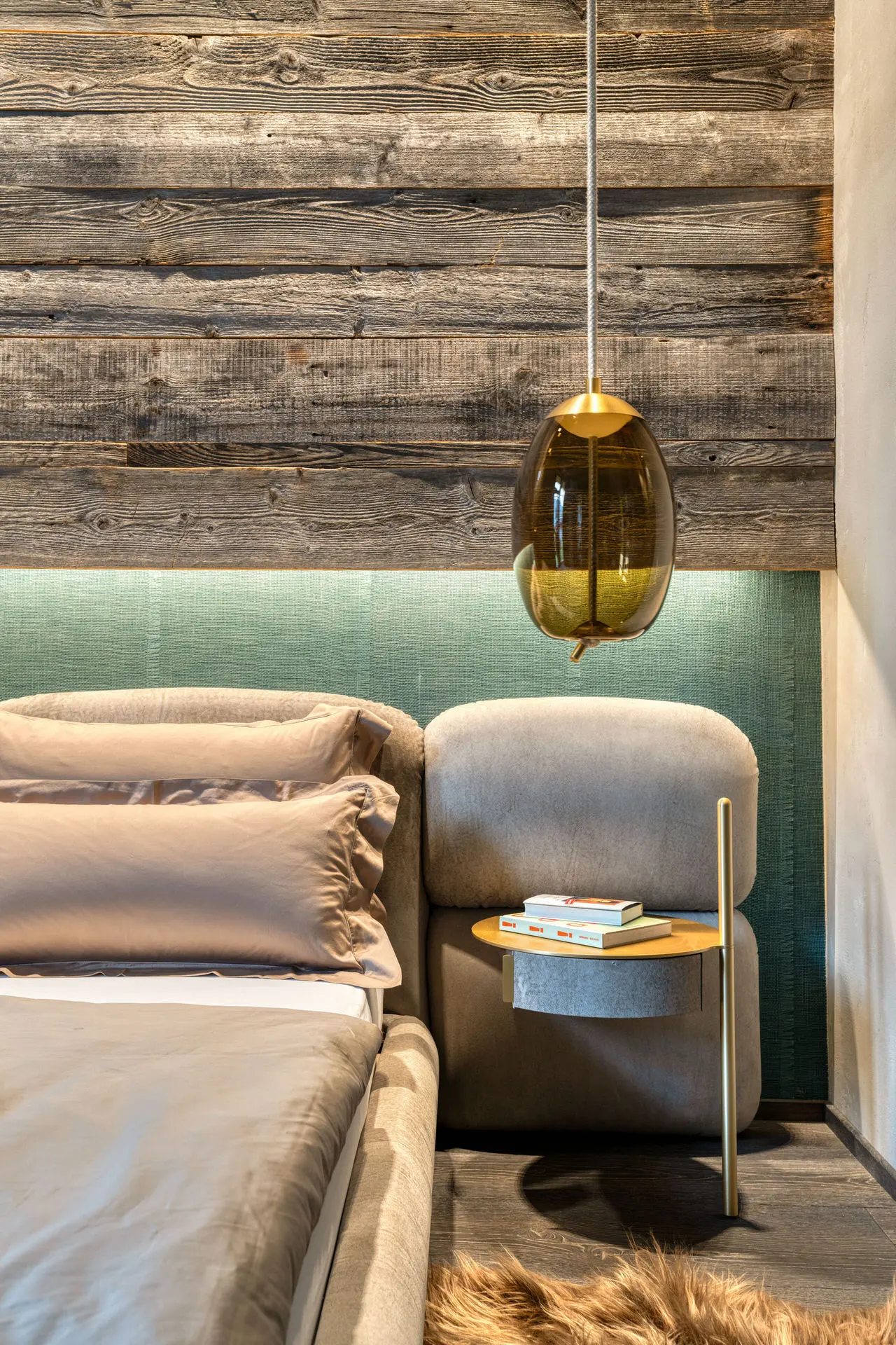 Baxter Stone bed headboard detail with gold pendant light