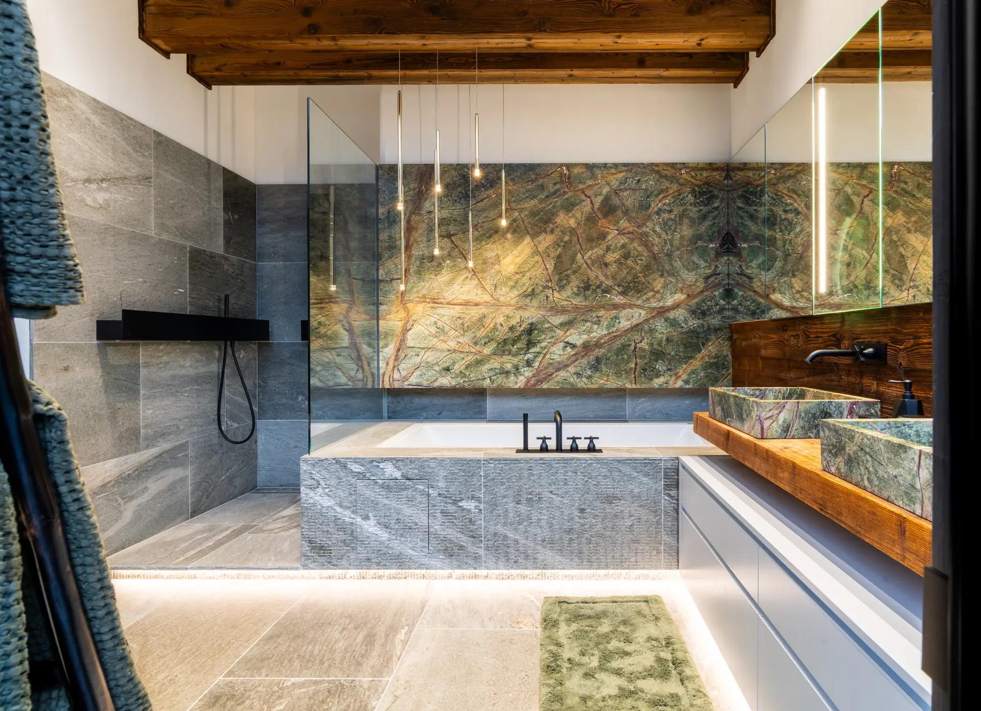 Green marble bathroom with Agape faucets in Kitzbuehel luxury chalet