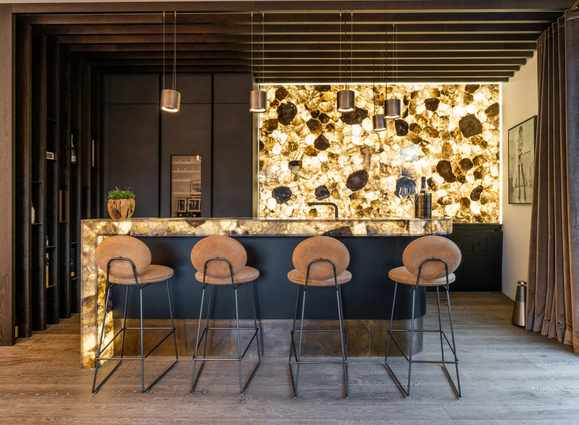 Home bar with backlit natural agate stone wall in luxury chalet