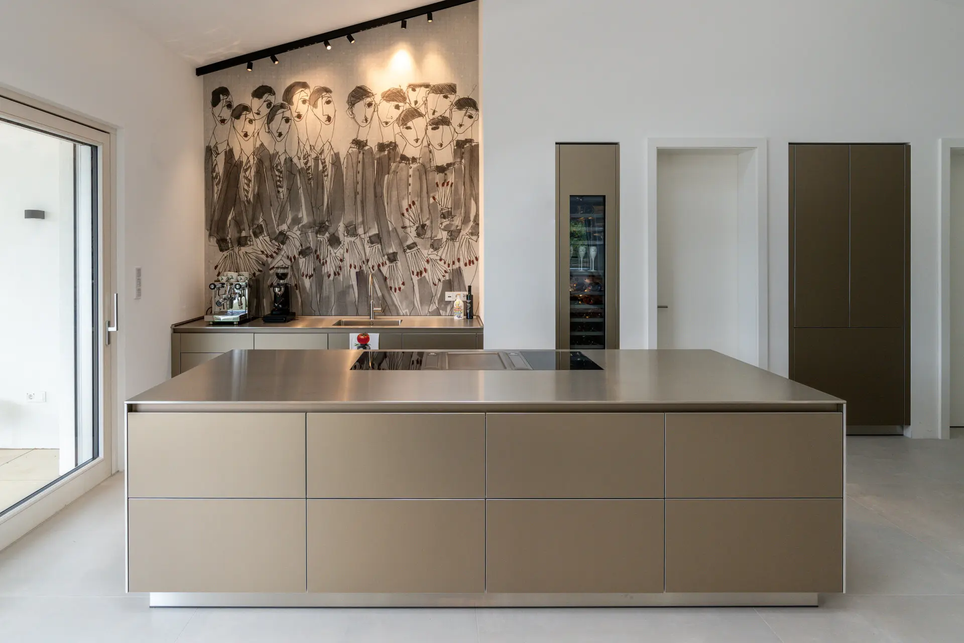 Kitchen island with bronze accents and hand-painted mural at Millstätter See