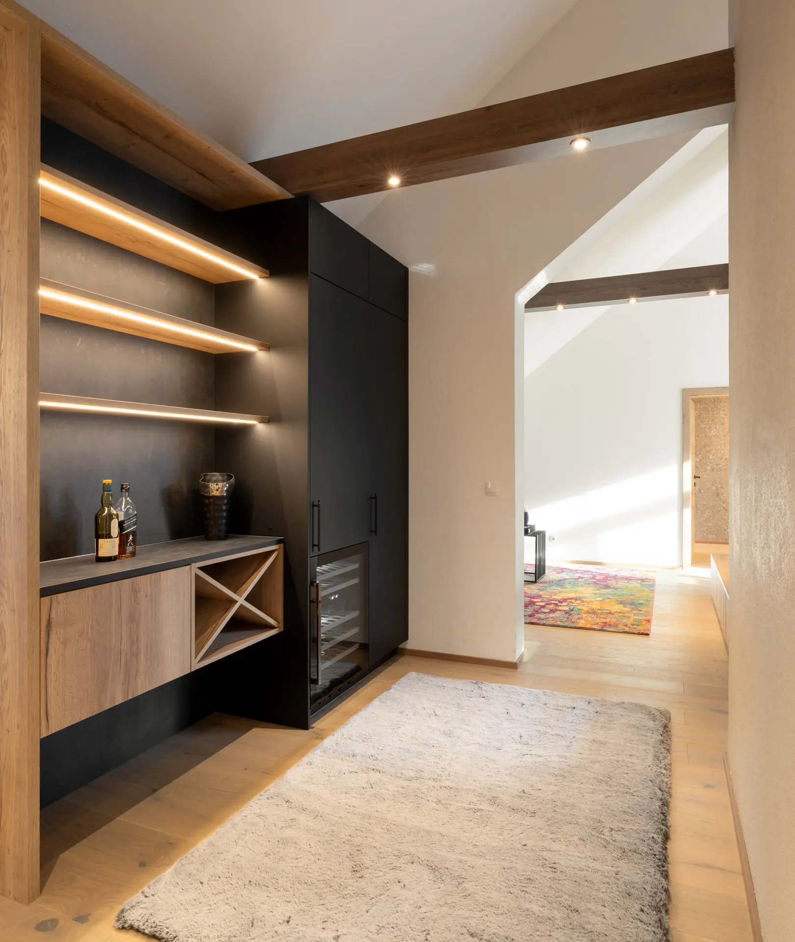 Backlit bar with integrated wine storage in Linz apartment