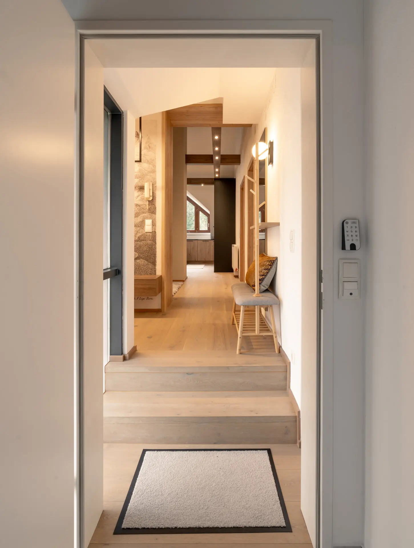 Entry hallway with warm corridor lighting in modern Linz apartment