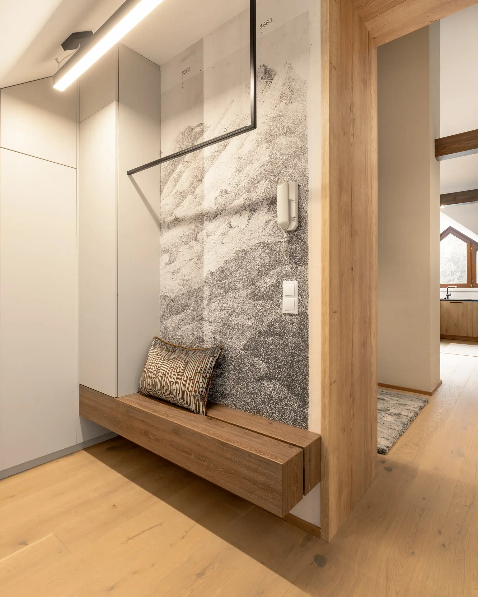 Hallway with floating bench and mural detail in Linz apartment