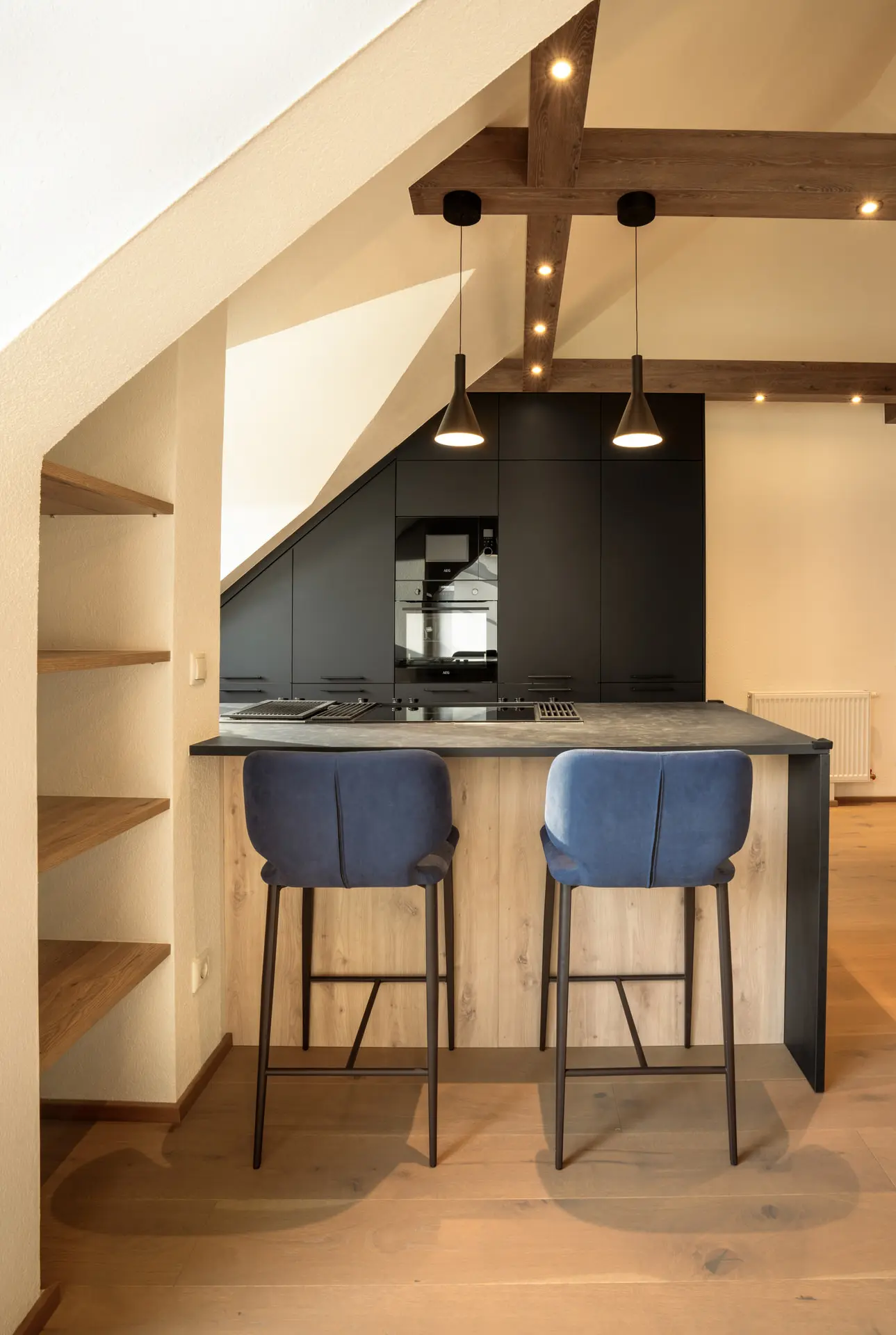 Kitchen island with blue barstools in modern Linz apartment