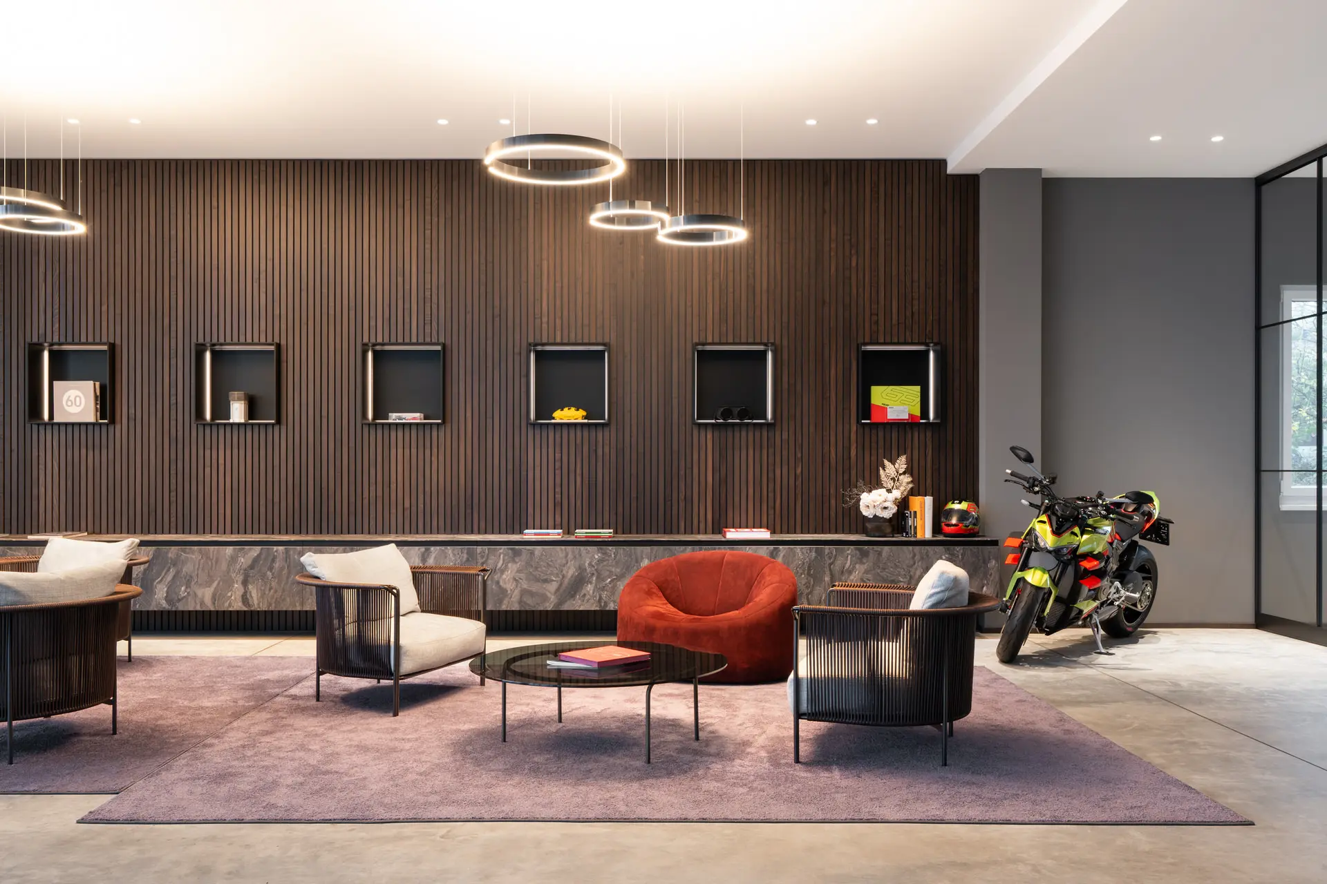 Lounge seating area with pendant lights in prestige auto showroom