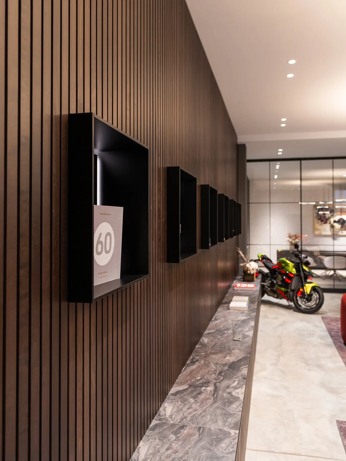 Custom slatted timber wall with display niches in auto showroom