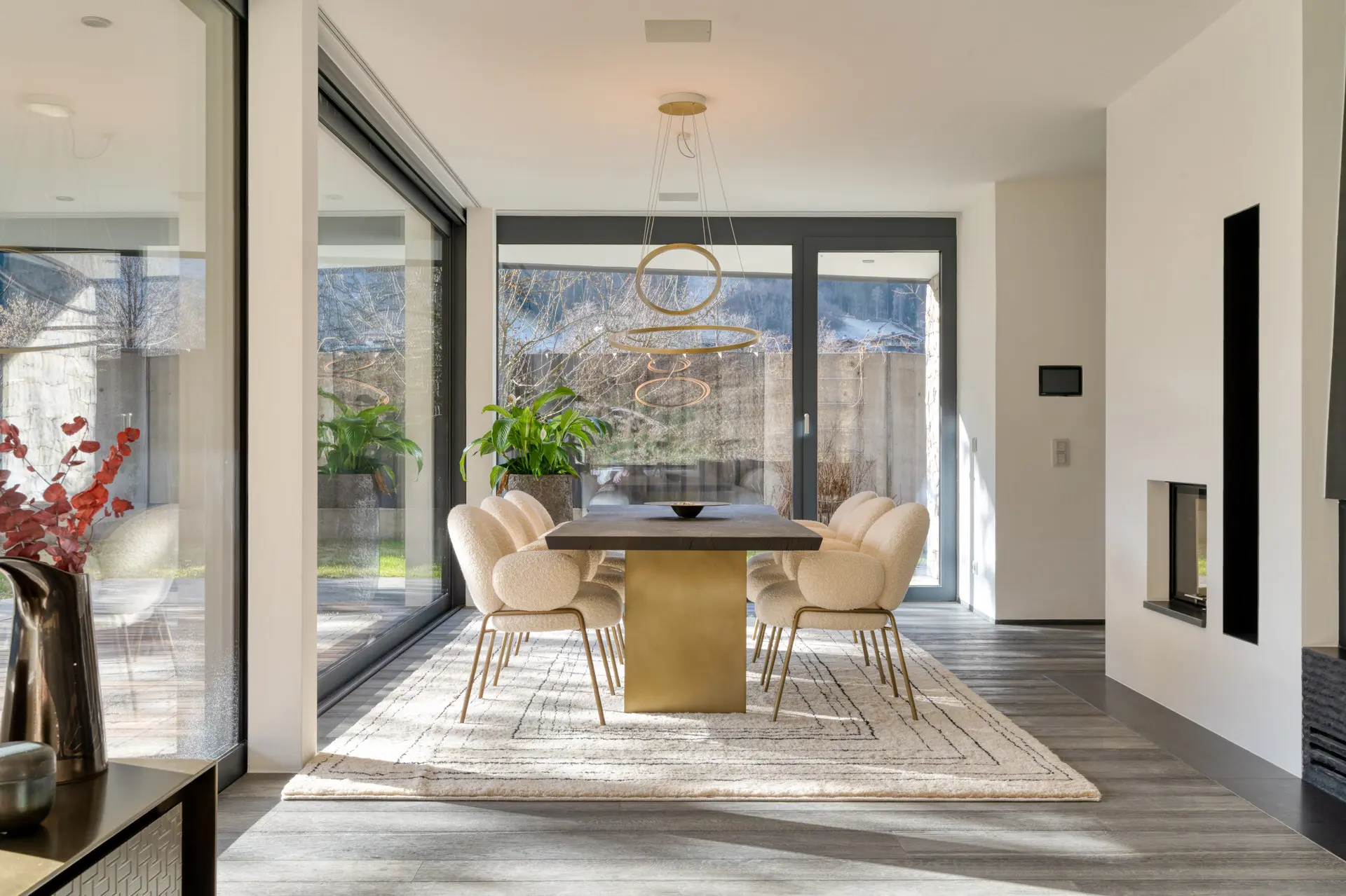 Dining table with gold pendant light in Kitzbuehel private villa