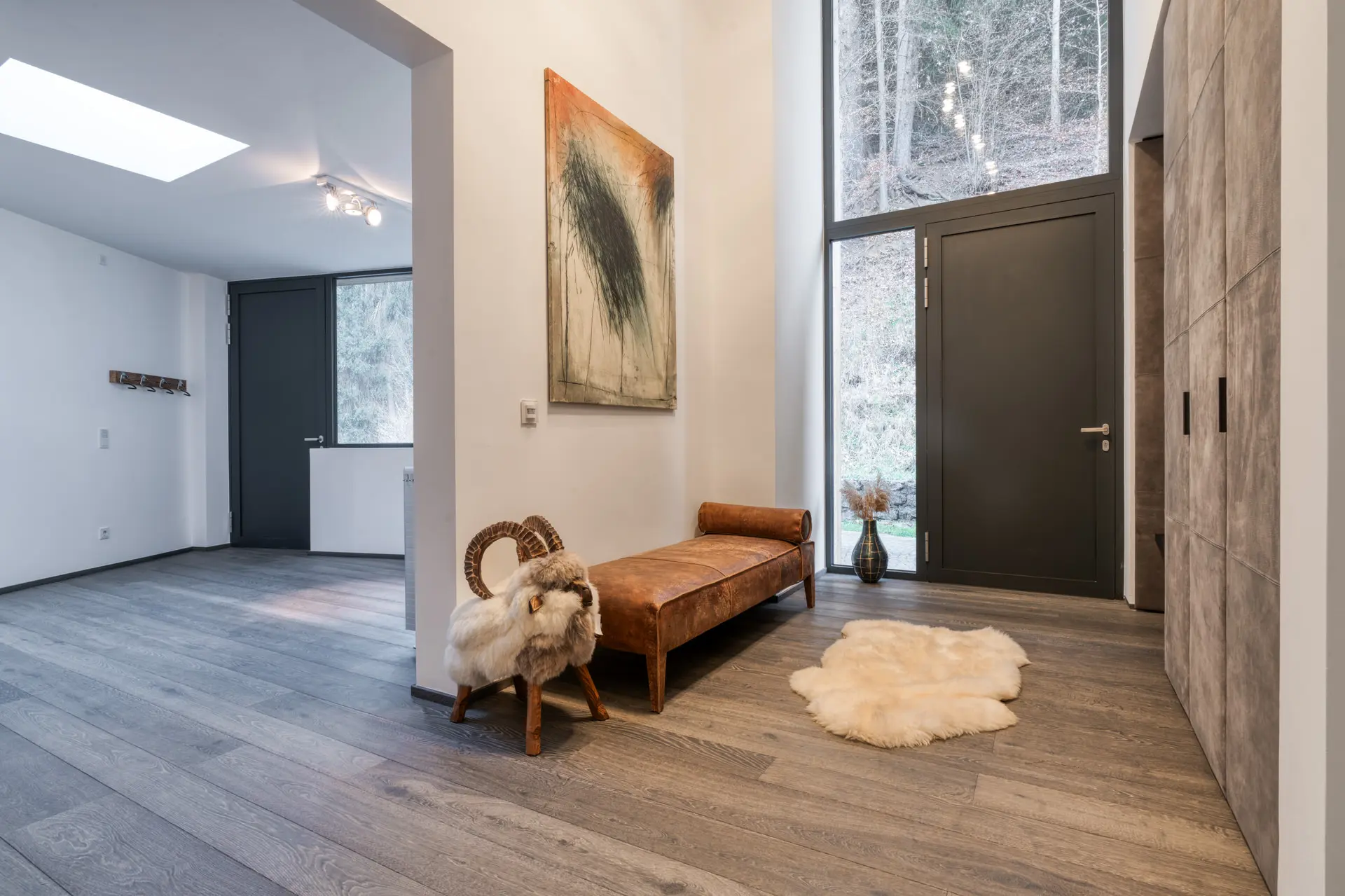 Foyer with high ceiling and curated artwork in Kitzbuehel luxury villa