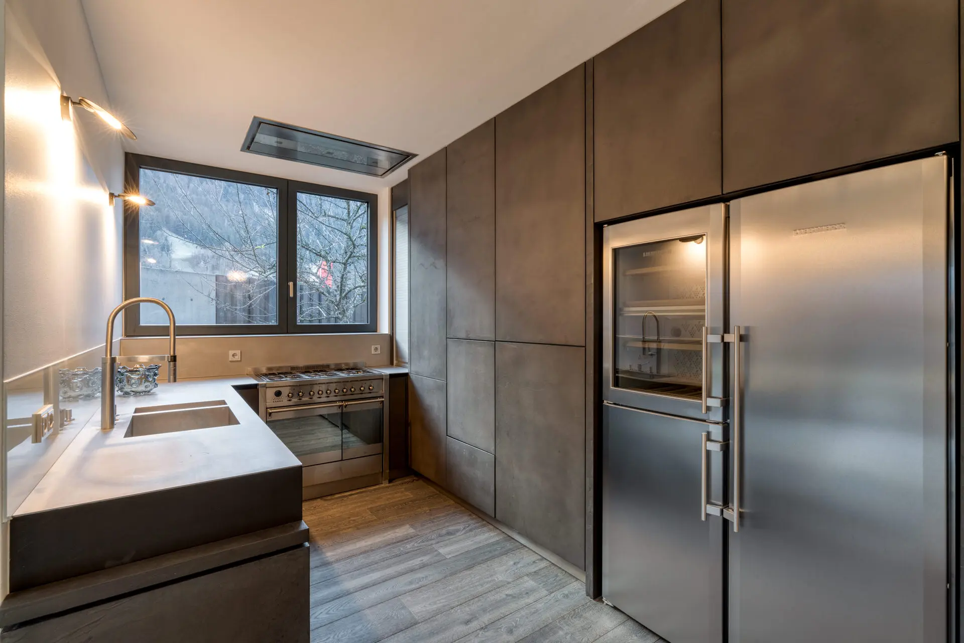 Kitchen with dark steel appliances in Kitzbuehel private villa