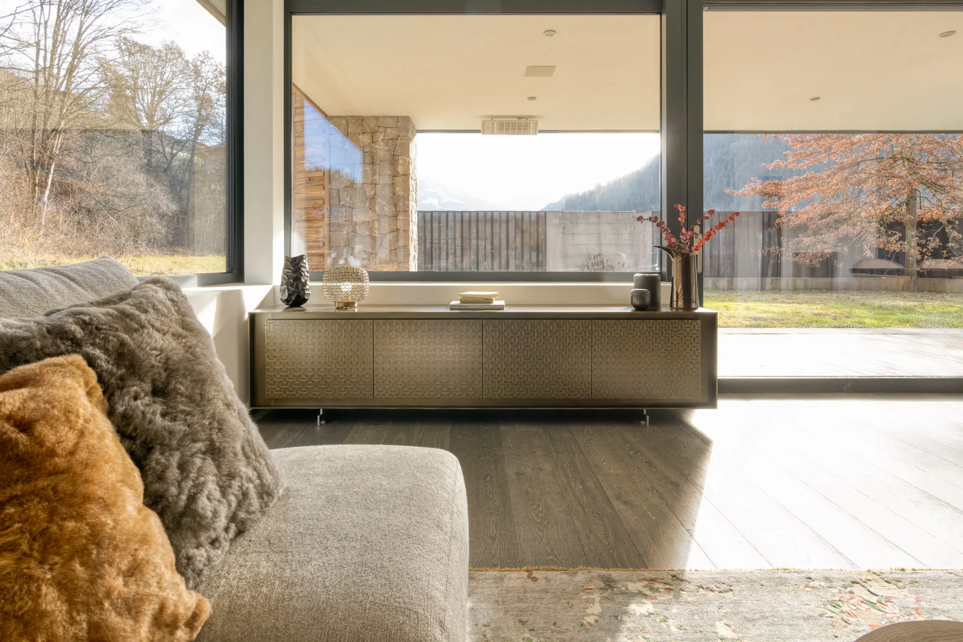 Living room sideboard with winter alpine view in Kitzbuehel residence