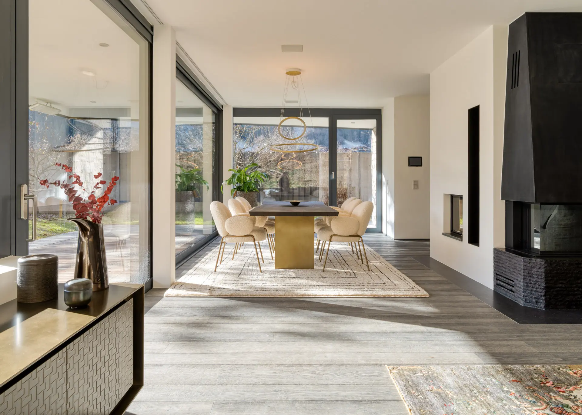 Open-plan dining area with fireplace in Kitzbuehel luxury residence