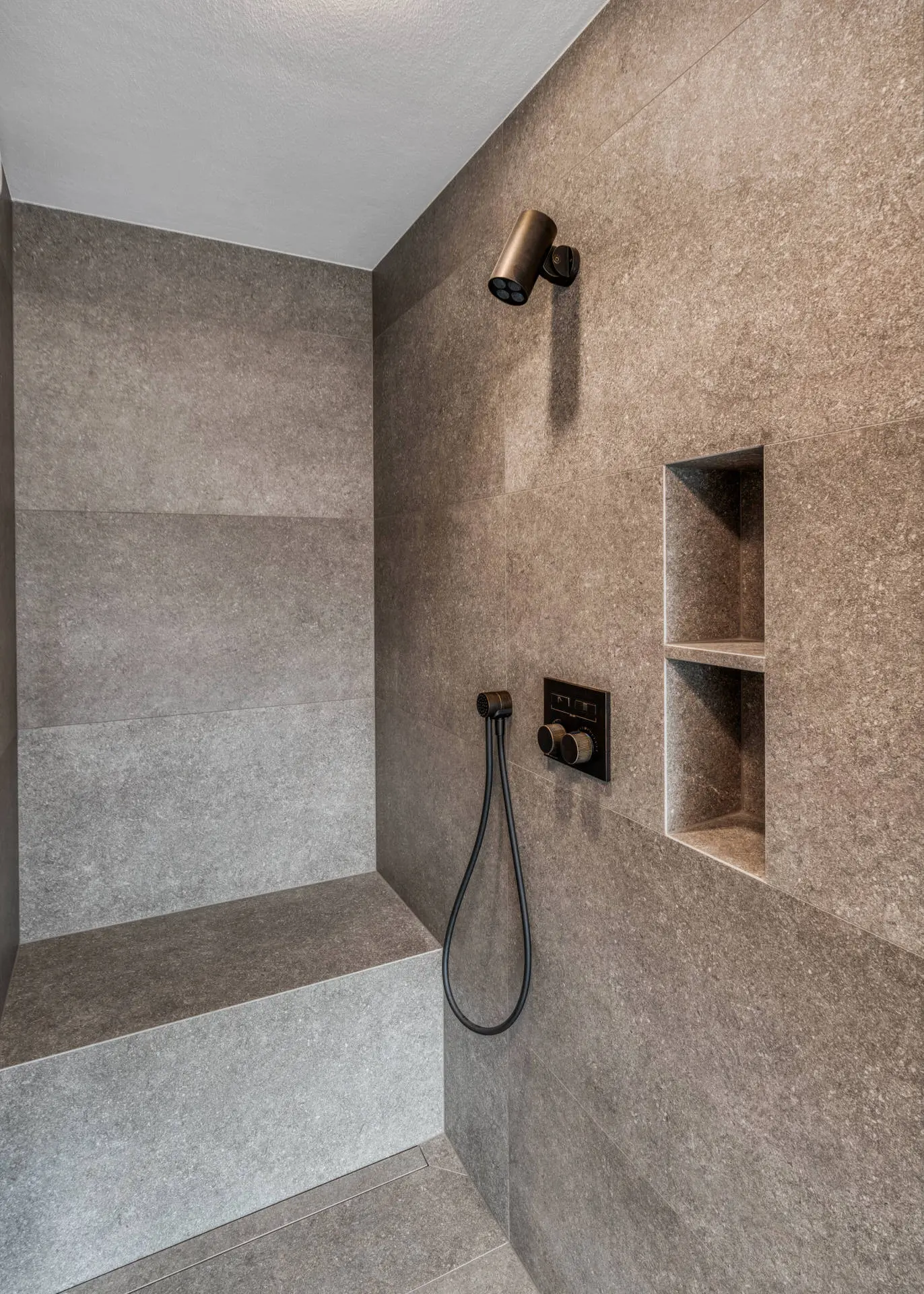 Shower with stone tile and niche detail in Kitzbuehel luxury villa